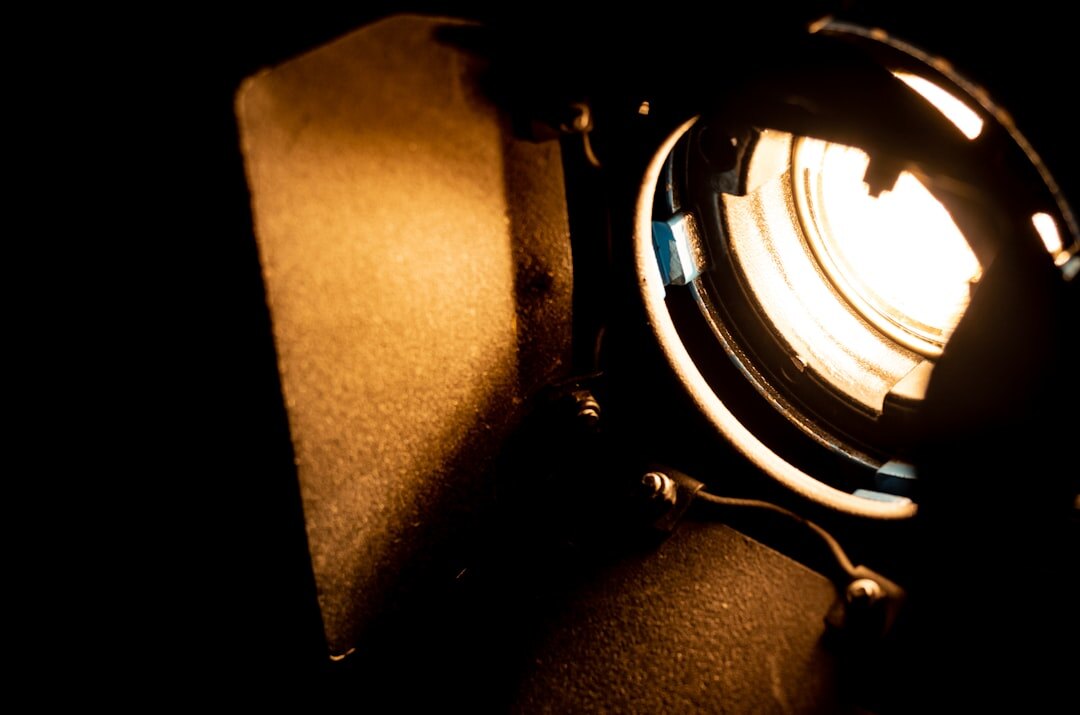 filmmaker adjusting camera settings in dark room