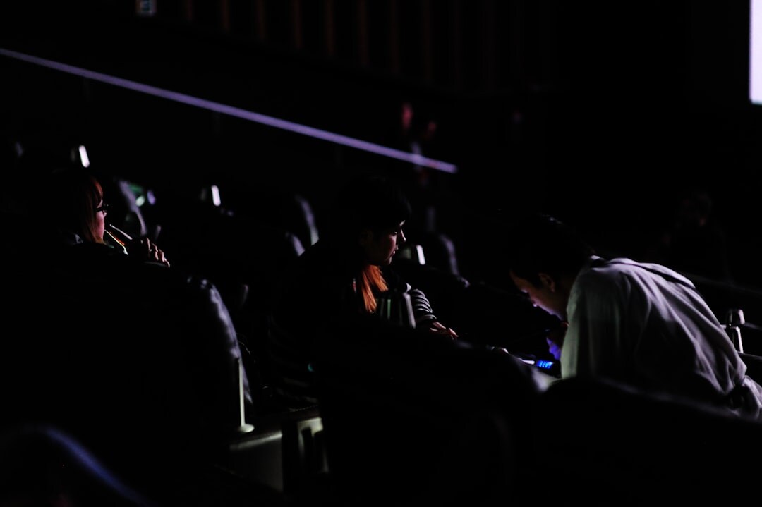 filmmaker adjusting camera settings in dark room